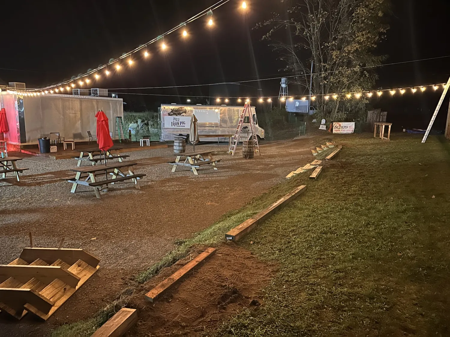 String lights over the Iron Pig backyard patio with the Iron Pig food truck